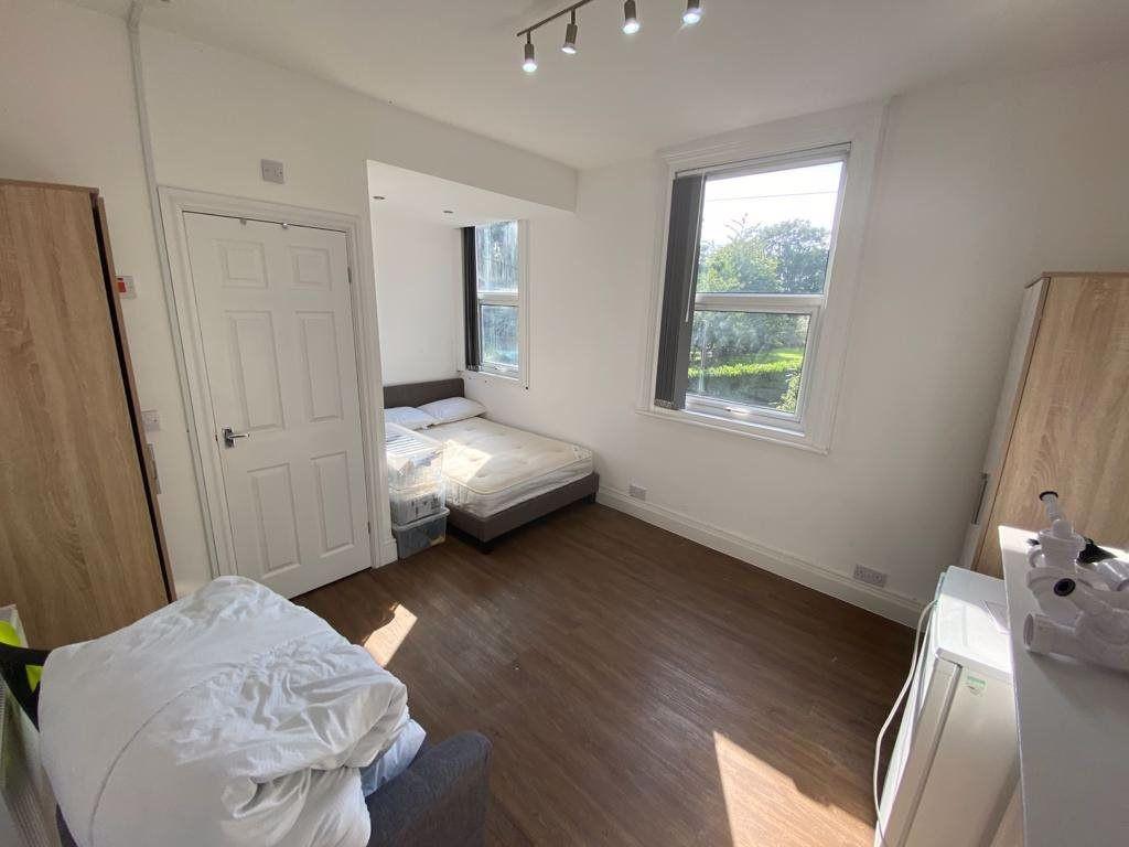 Bright and airy bedroom featuring large windows...