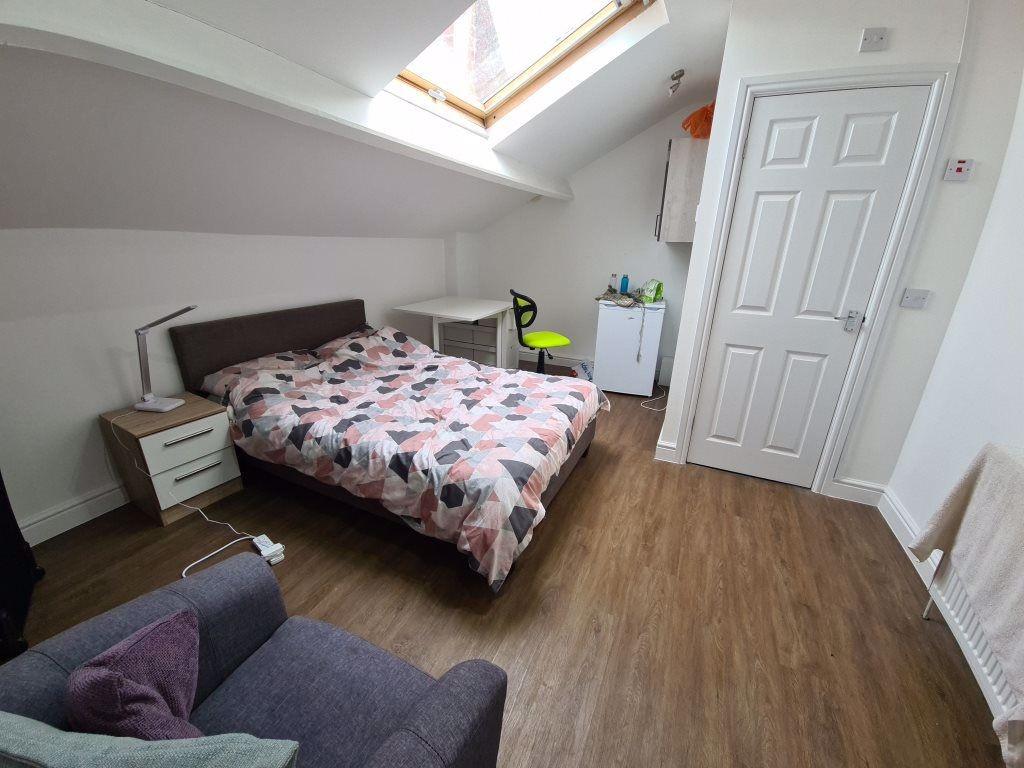 A bright and tidy bedroom featuring a double be...