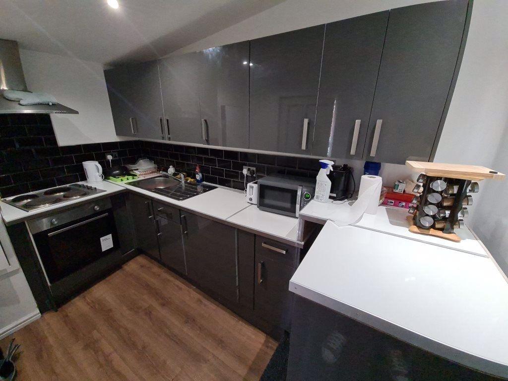 Modern and tidy kitchen with sleek dark cabinet...
