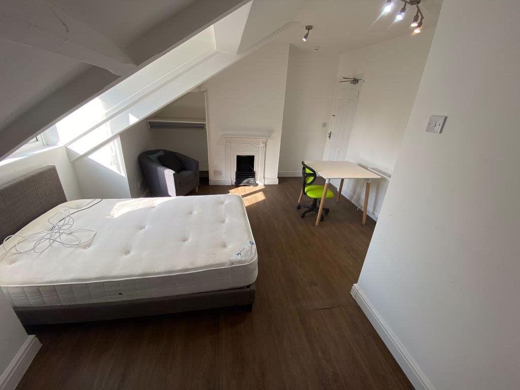 A bright and spacious double bedroom with natur...