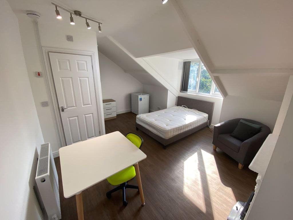 A bright and tidy bedroom featuring a double be...