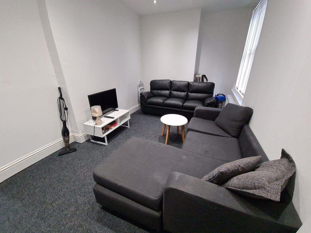 A spacious and modern living room featuring a l...