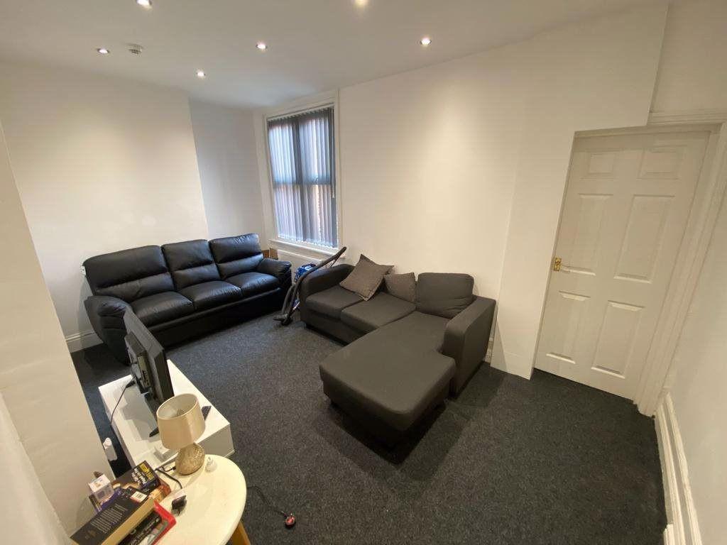 A spacious and modern living room featuring com...