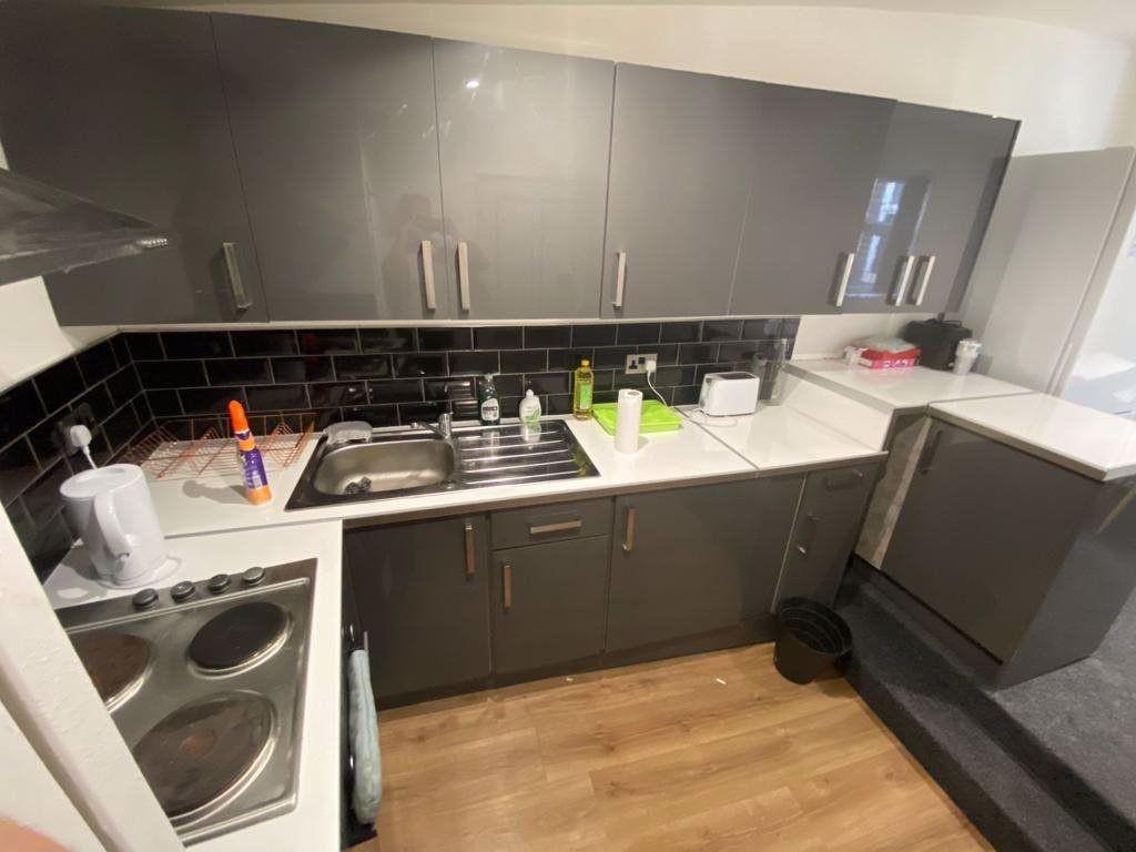 A modern, well-organized kitchen with sleek gra...