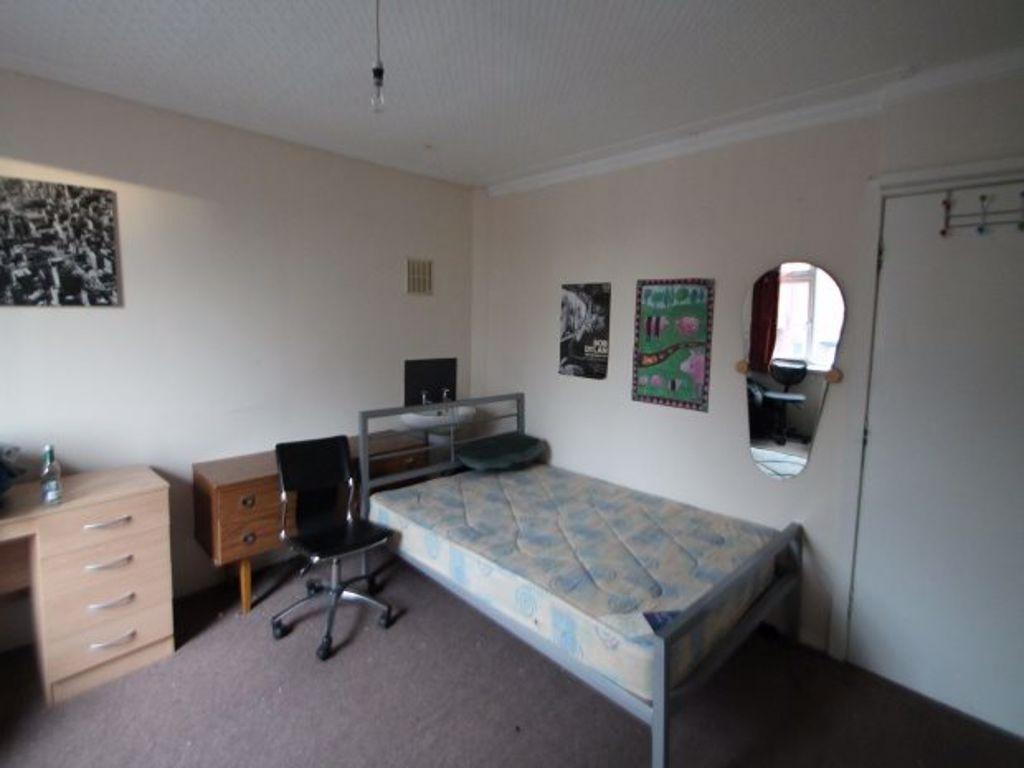 A tidy and well-lit bedroom featuring a single ...