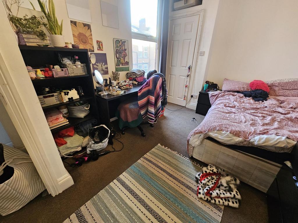 Bright, furnished bedroom with a double bed, co...
