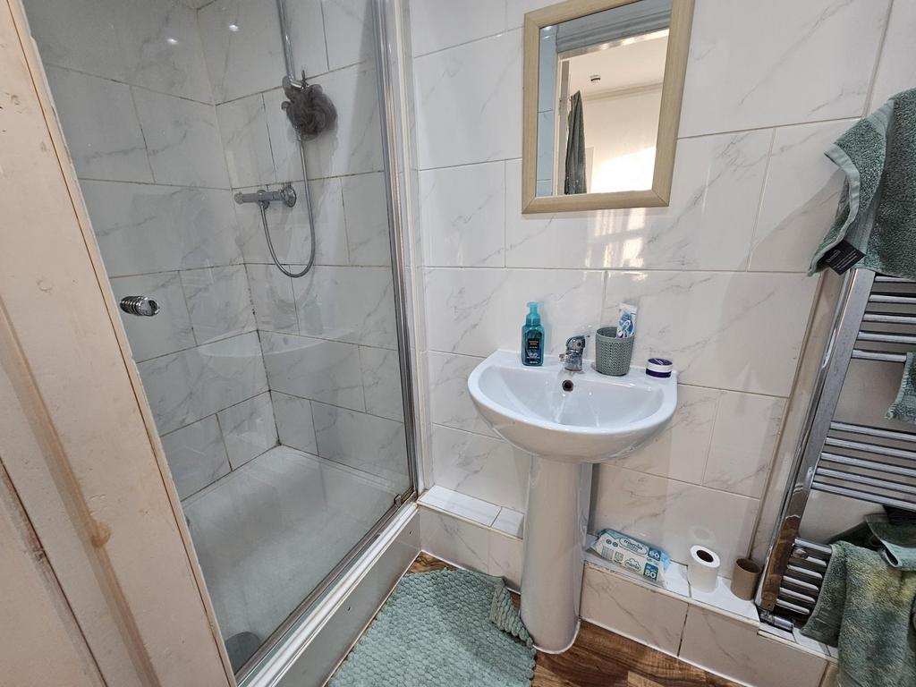 Bright, modern bathroom with a tiled walk-in sh...