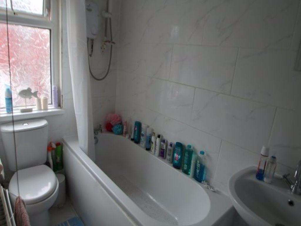 A well-maintained bathroom featuring a large ba...