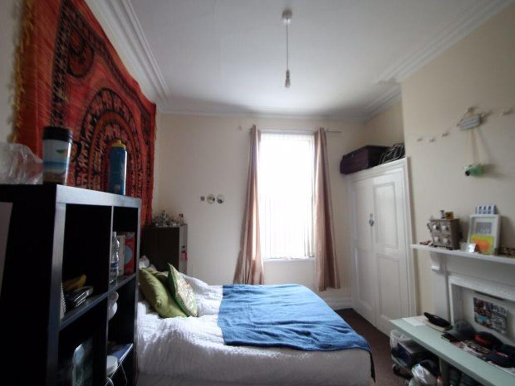 A spacious and well-lit master bedroom featurin...