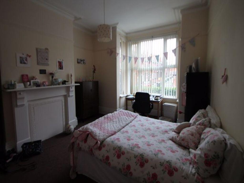 A cozy and well-maintained bedroom featuring a ...