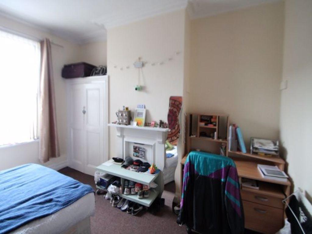A cozy student bedroom featuring a single bed, ...
