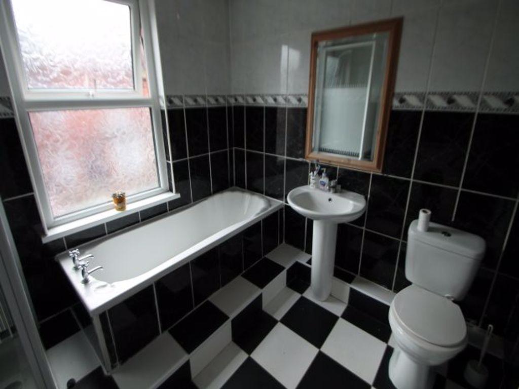 A spacious bathroom featuring a large bathtub, ...