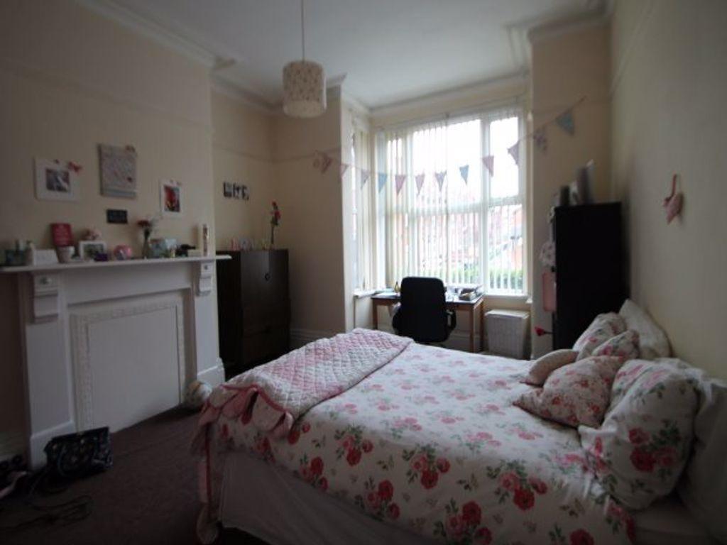 A cozy, well-maintained bedroom featuring a com...