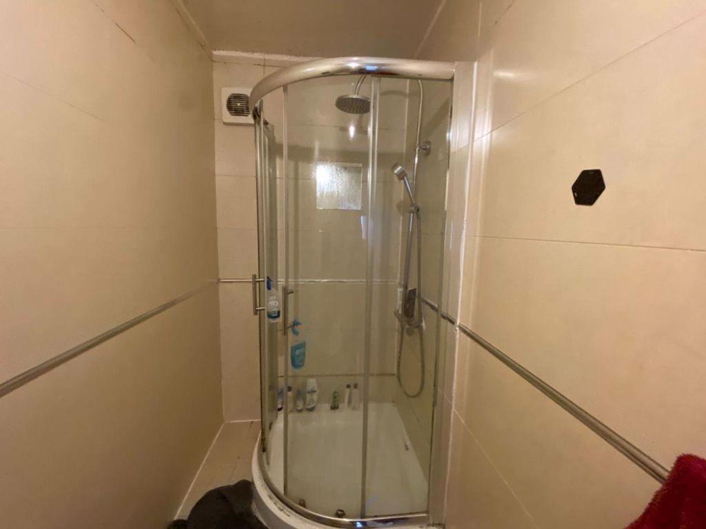 A clean and spacious bathroom with a large show...