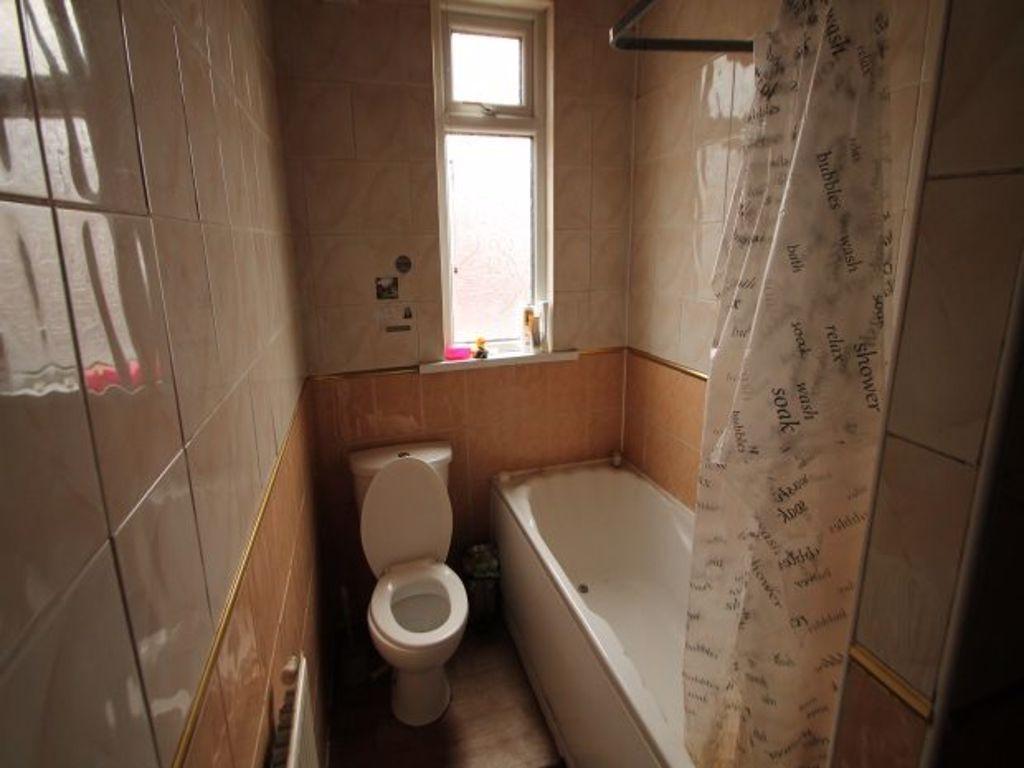 A well-maintained bathroom featuring a bathtub ...