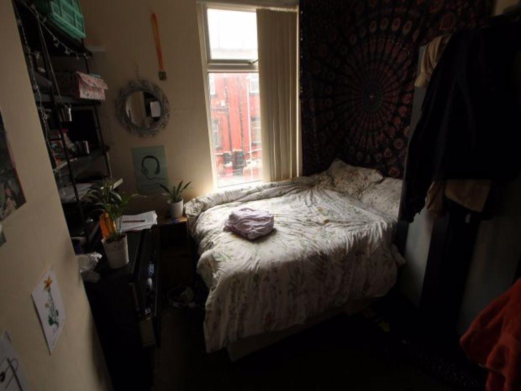 A cozy and well-maintained bedroom featuring a ...