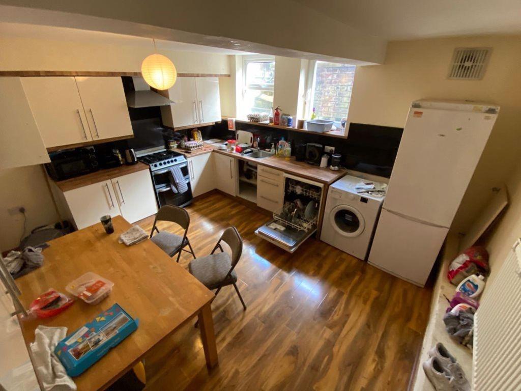 A well-lit kitchen area with modern appliances ...
