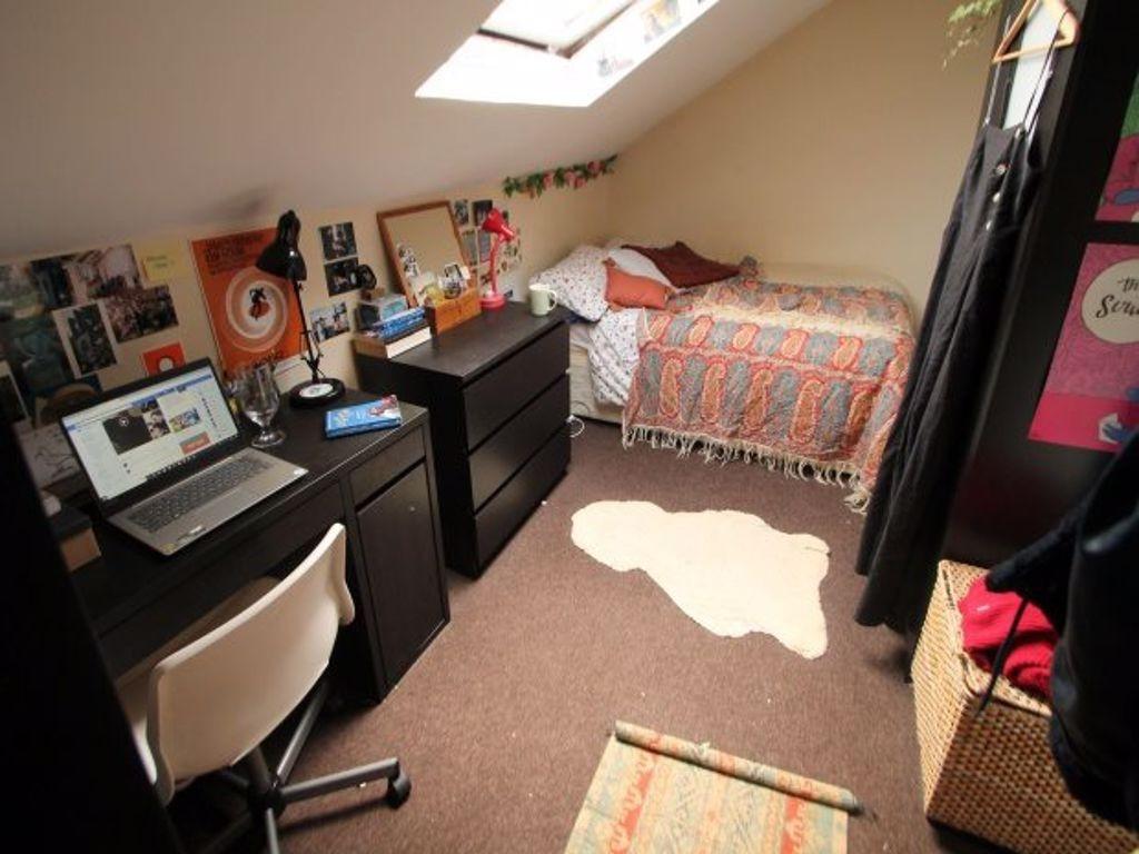 A cozy bedroom featuring a comfortable bed with...