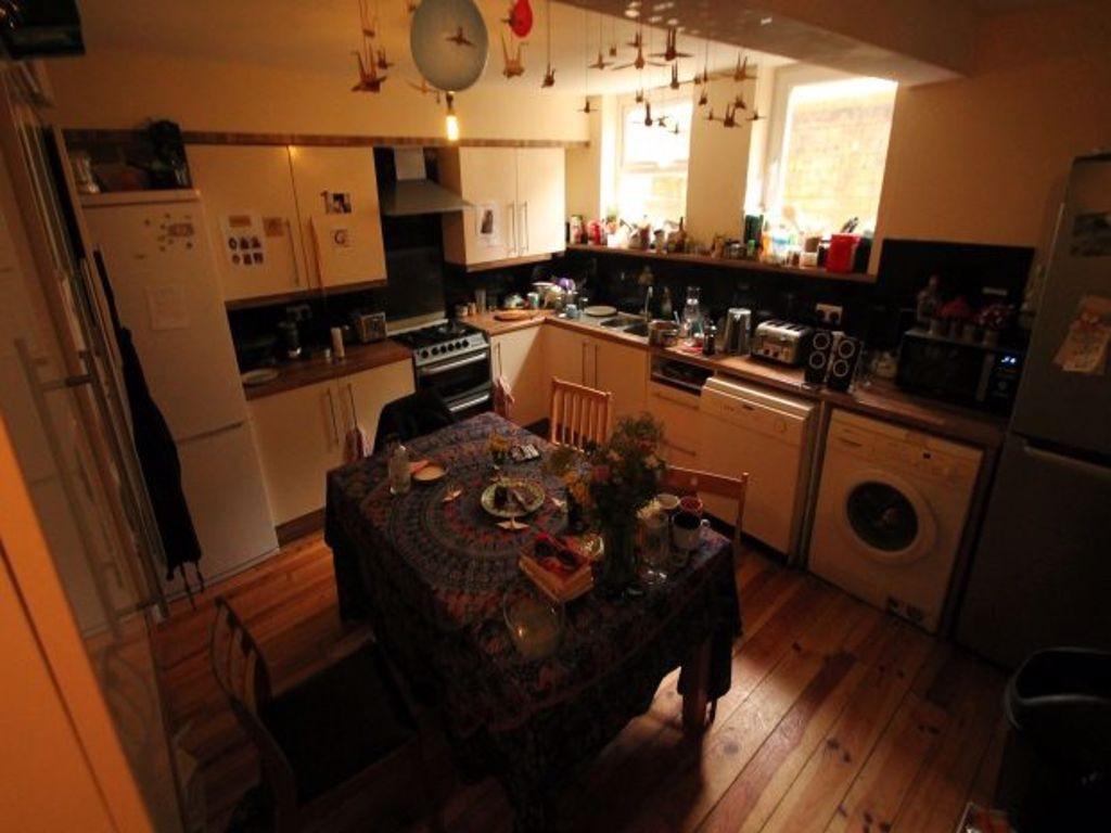 A cozy kitchen with a dining table, well-lit wi...