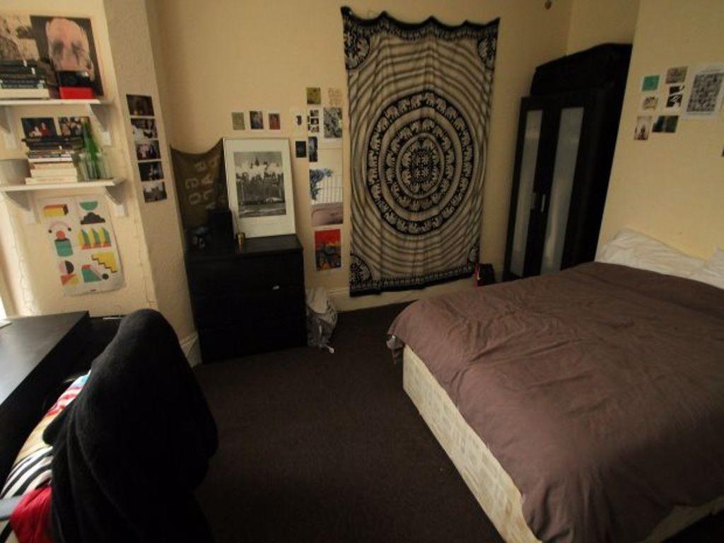 A cozy bedroom featuring a comfortable double b...
