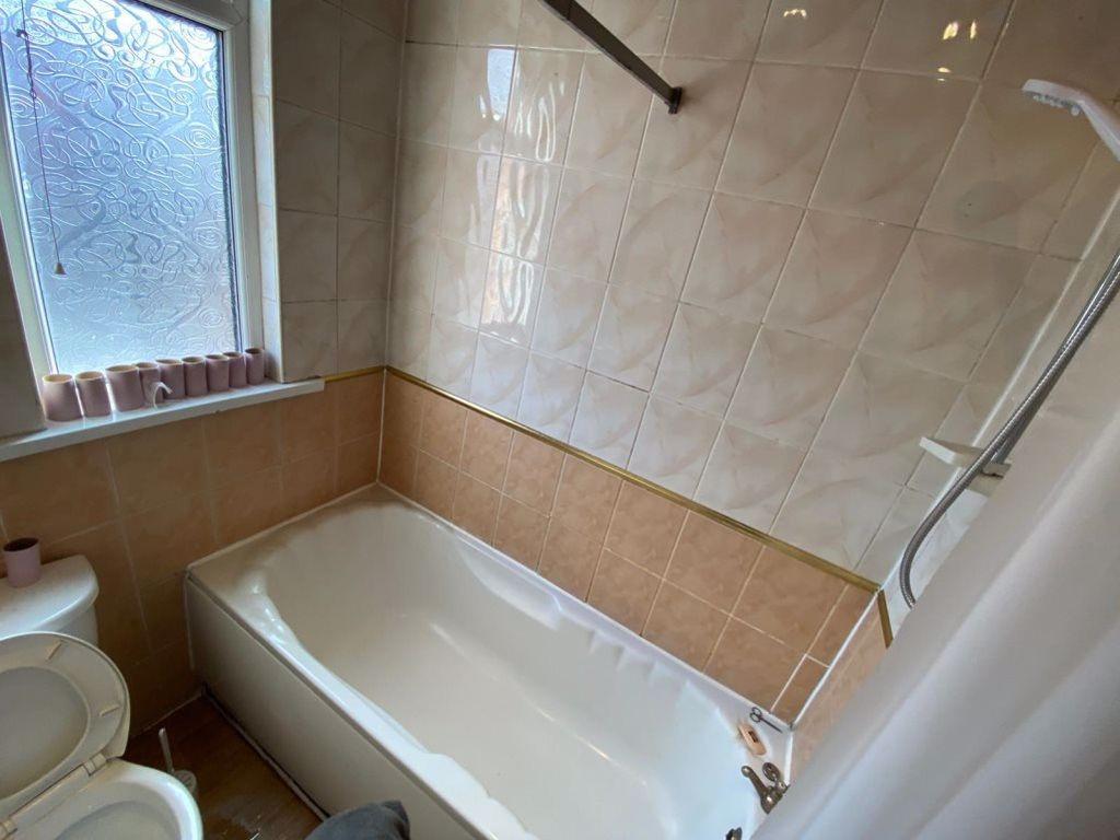 A spacious and well-maintained bathroom with a ...