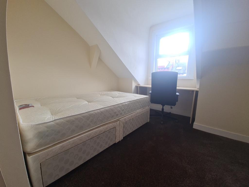 Bright and spacious master bedroom featuring a ...