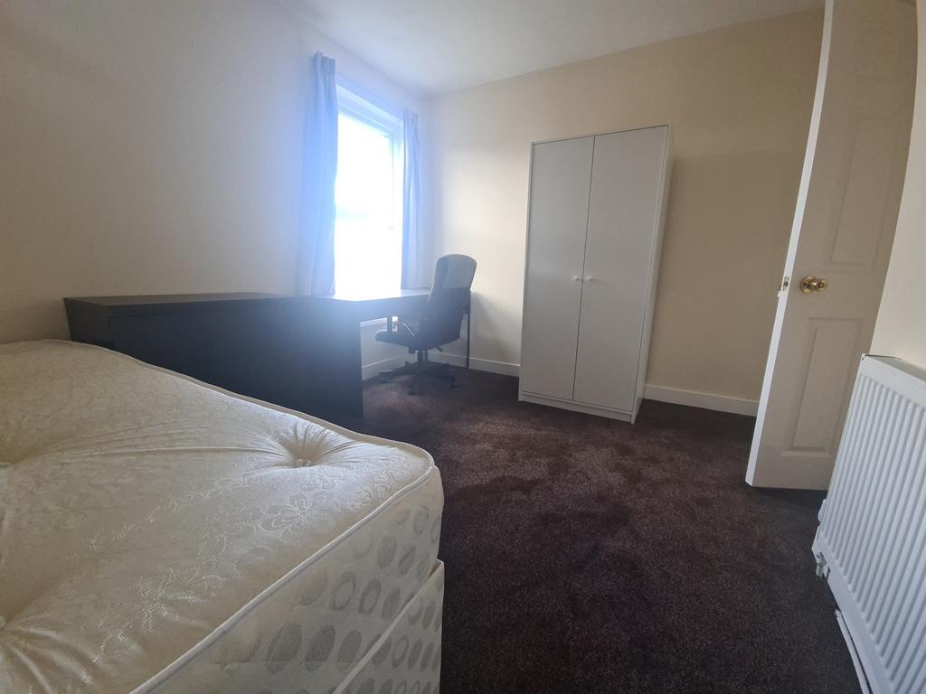 A comfortable double bedroom featuring a cozy s...