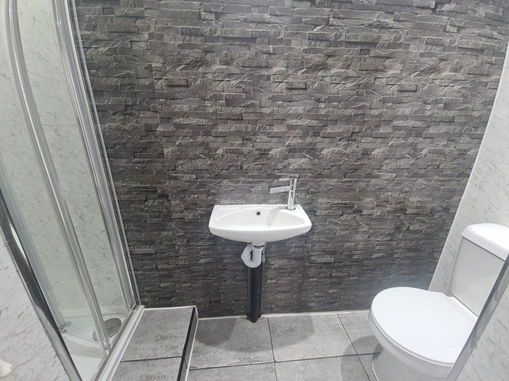 A clean, modern bathroom featuring a toilet, a ...