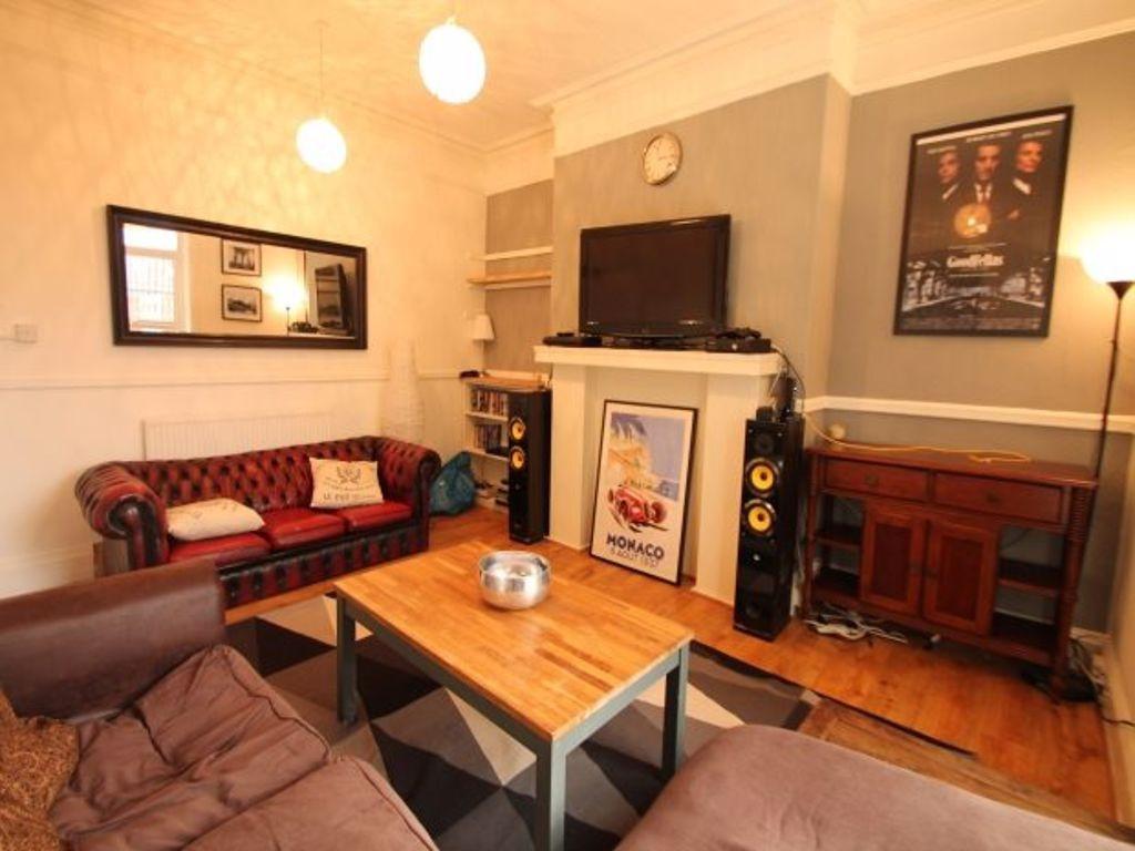 A spacious, well-lit living room featuring comf...