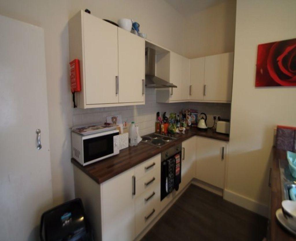 A well-maintained kitchen area with modern appl...