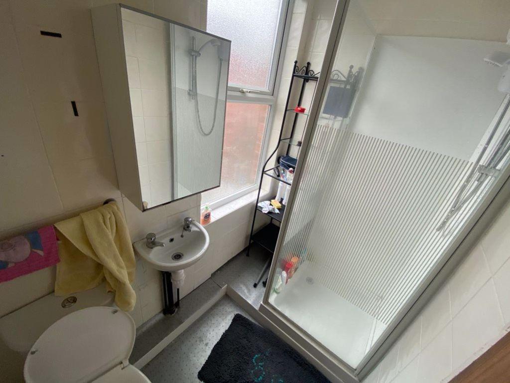 A bright and tidy bathroom featuring a modern s...