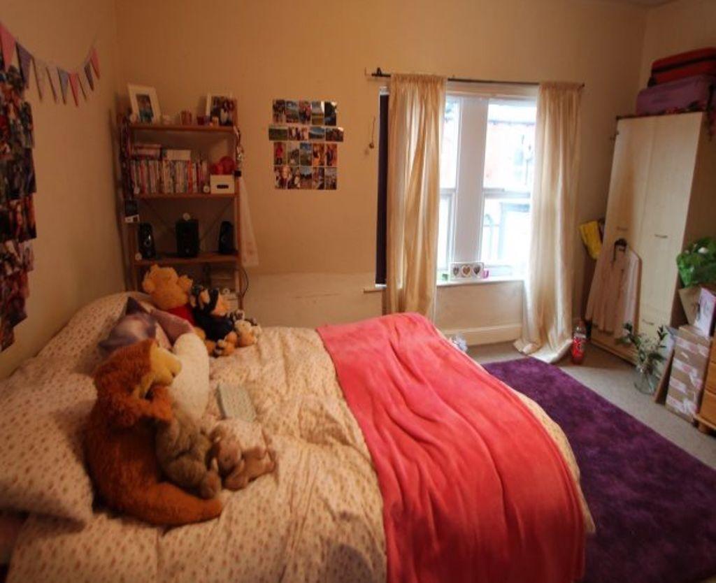 A bright and welcoming double bedroom featuring...