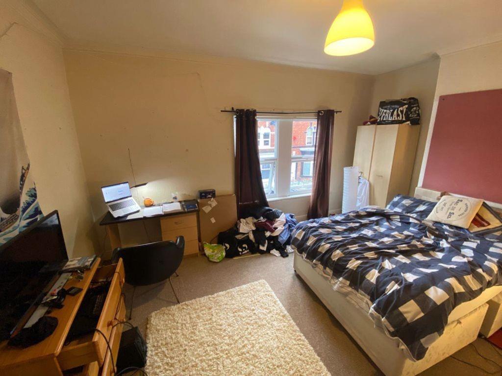 A cozy bedroom featuring a comfortable bed with...