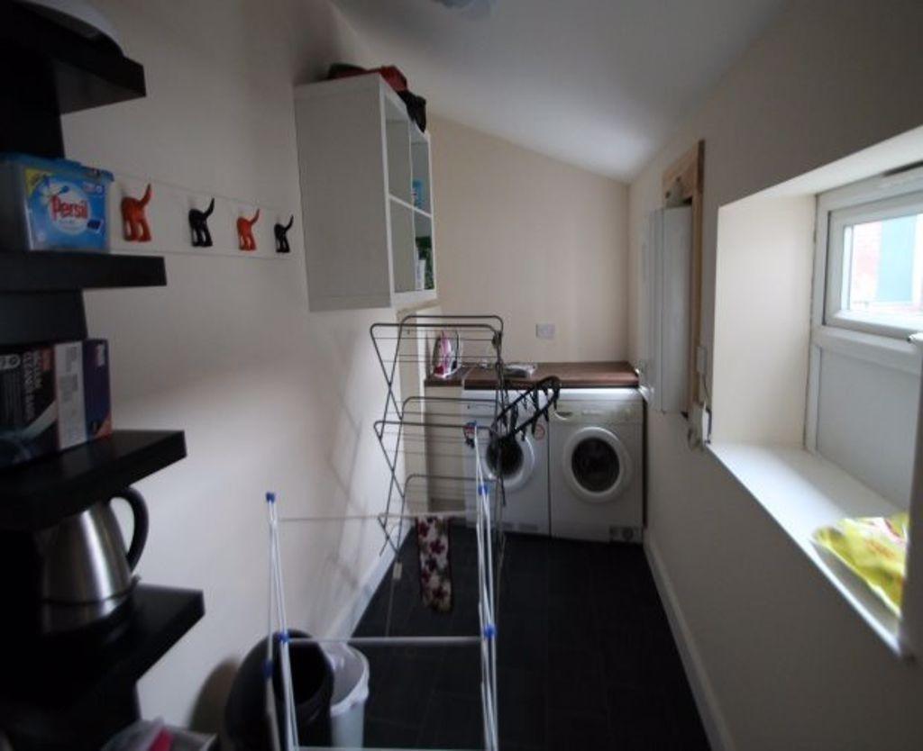 A functional bathroom with a washing machine an...