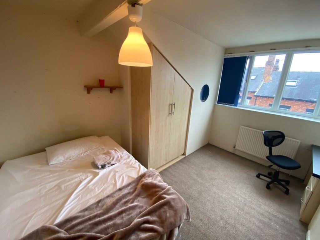 Bright and tidy bedroom with a comfortable bed,...