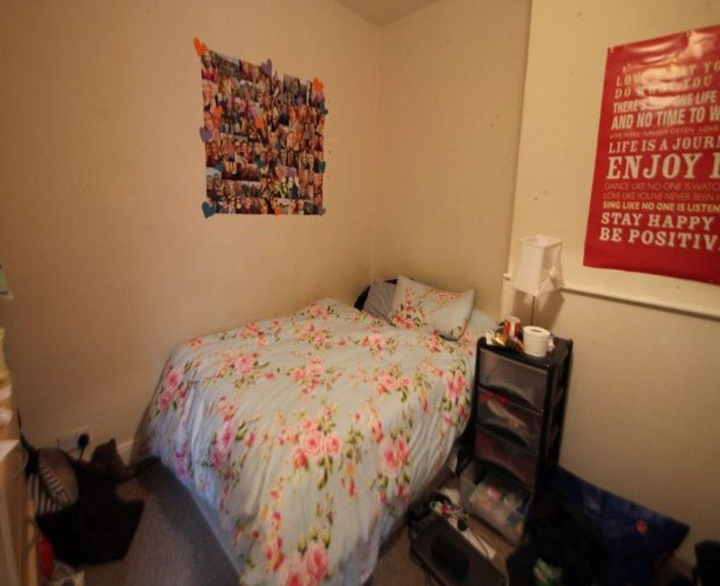 A cozy double bedroom featuring a neatly made b...