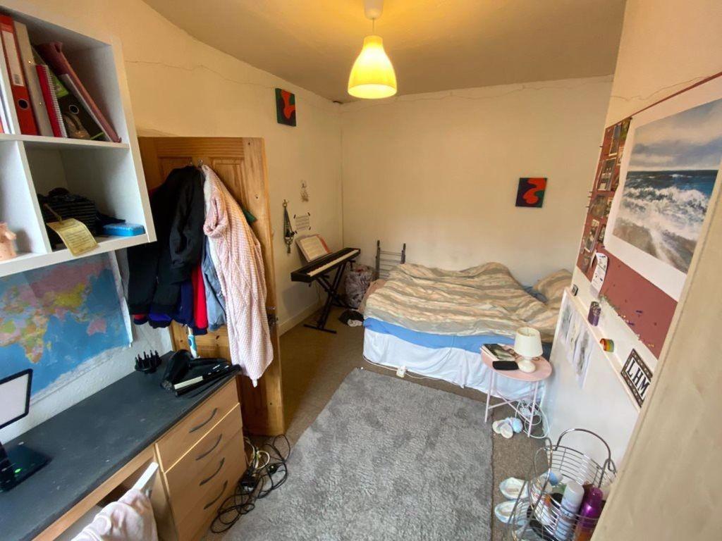 A cozy bedroom featuring a double bed, with a d...