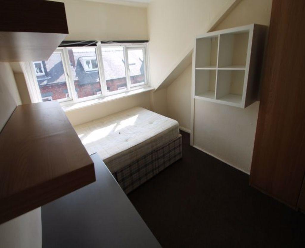A cozy single bedroom featuring a comfortable b...