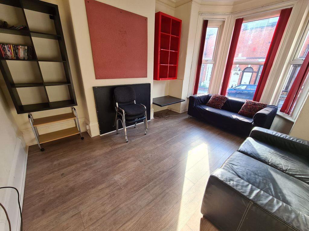 Bright and spacious living room featuring large...