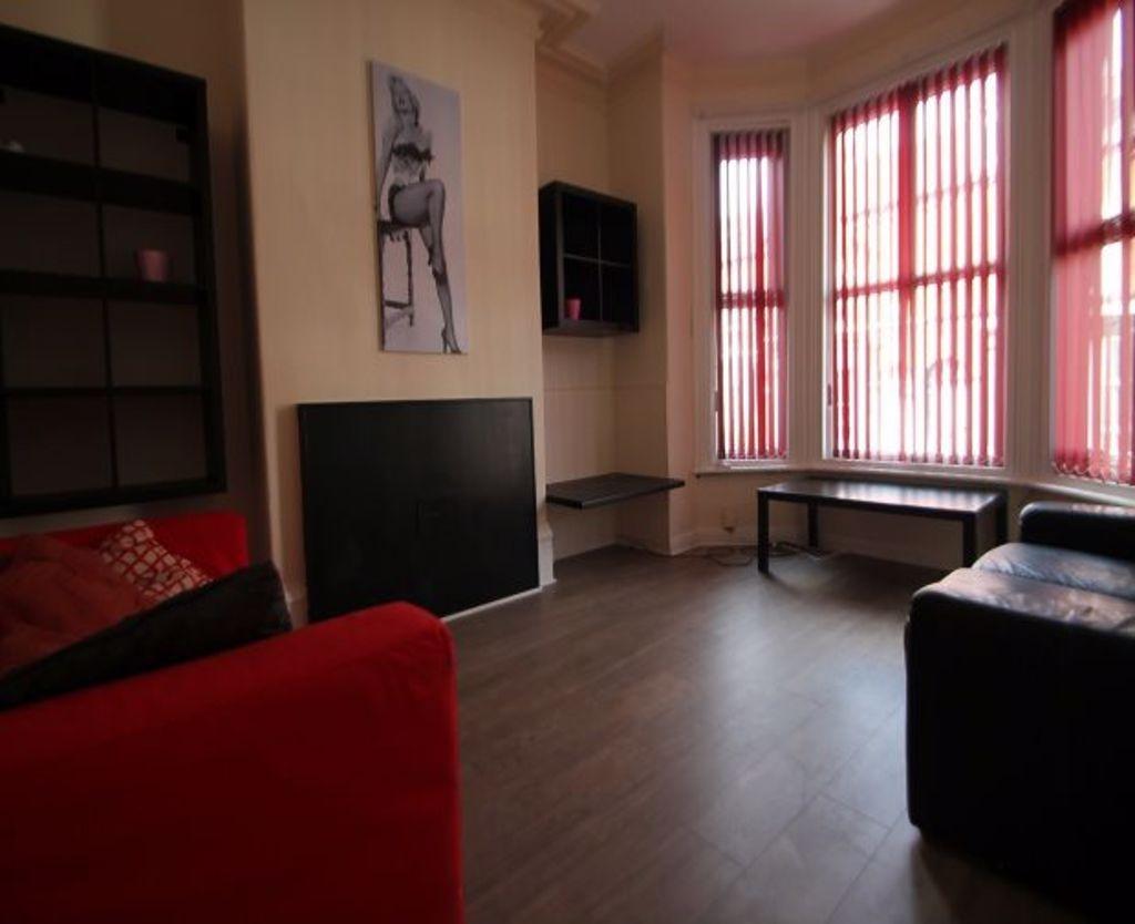 Spacious and well-lit living room with large wi...