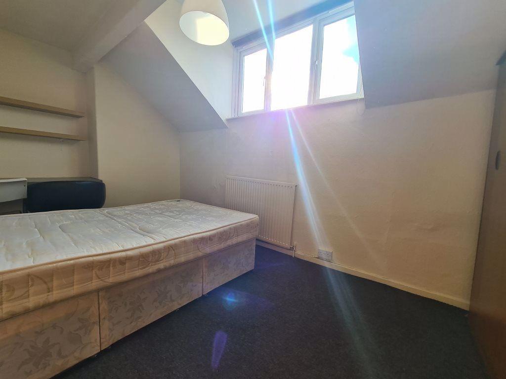 A cozy bedroom with a spacious bed, bright natu...