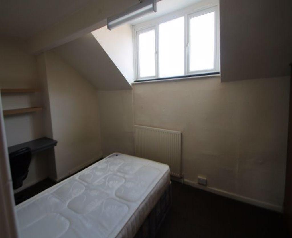 A cozy bedroom with a single bed near a window ...