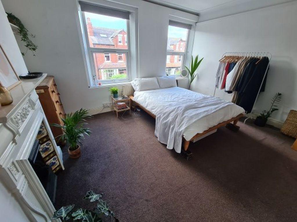 A bright and inviting master bedroom featuring ...