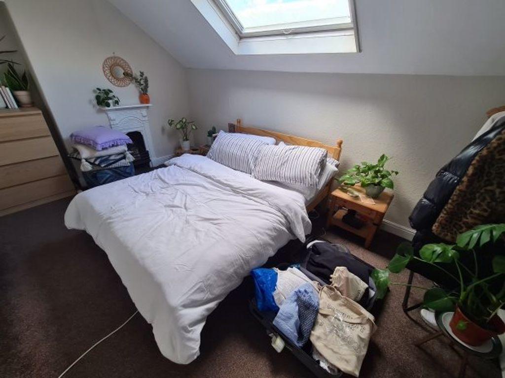 A well-lit, spacious double bedroom with a cozy...