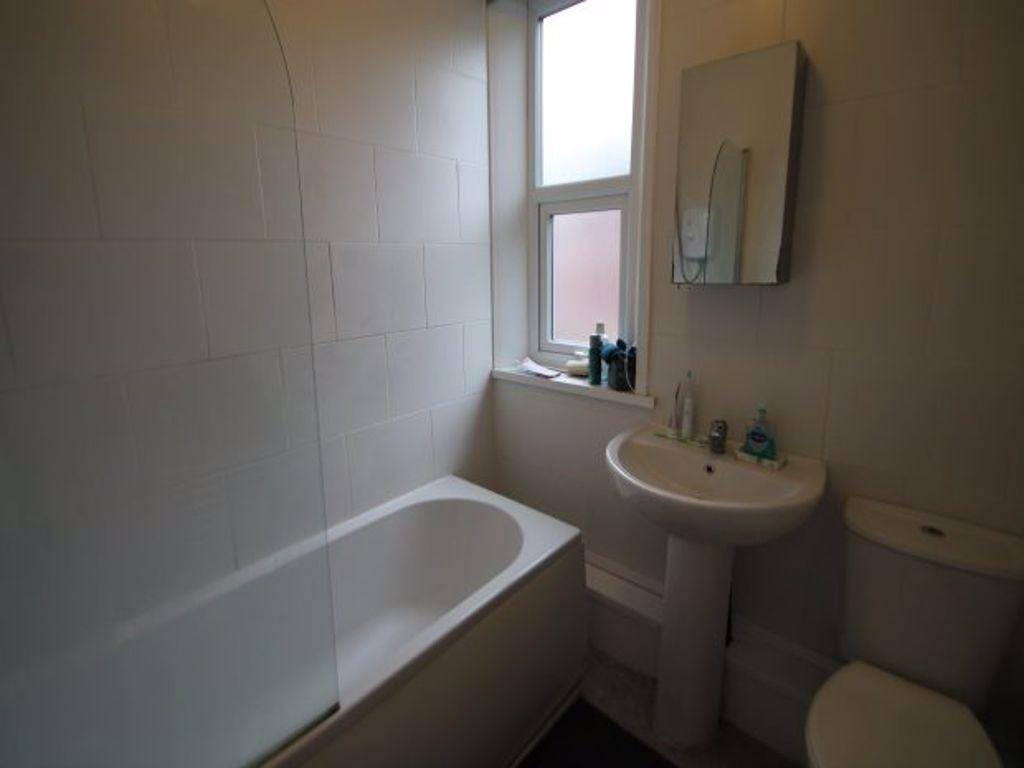 A clean, functional bathroom with a bathtub, si...