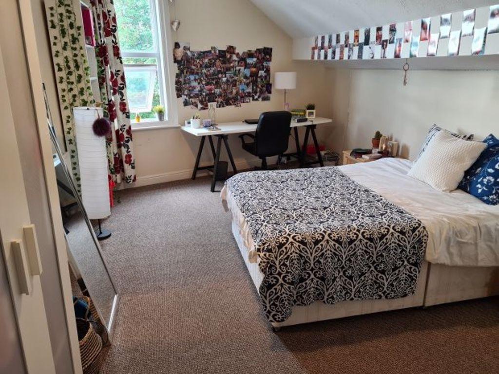 Spacious master bedroom featuring a large bed, ...
