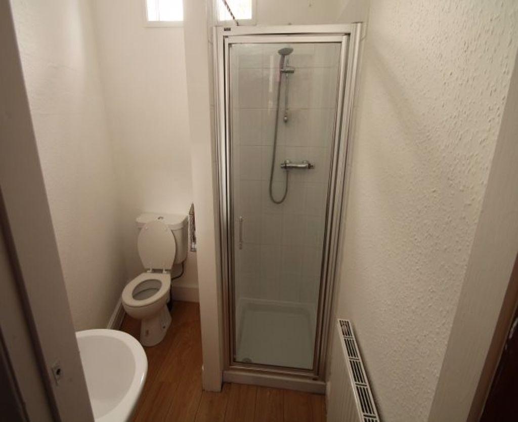 A clean and modern bathroom featuring a shower ...