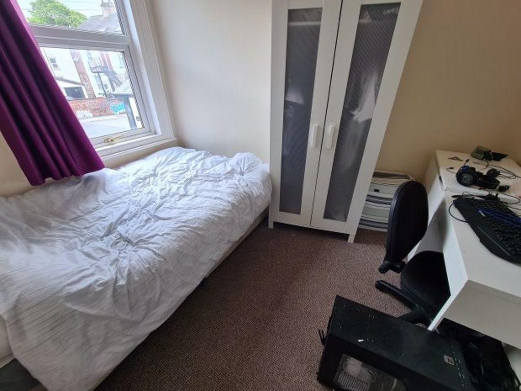 A cozy bedroom featuring a comfortable double b...