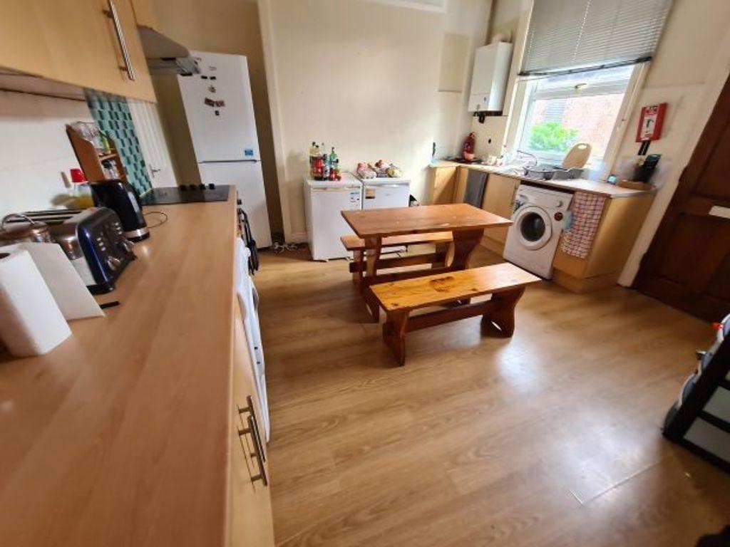 Bright and well-maintained kitchen with wooden ...