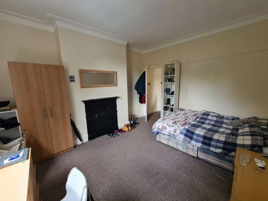 A spacious master bedroom featuring a large dou...
